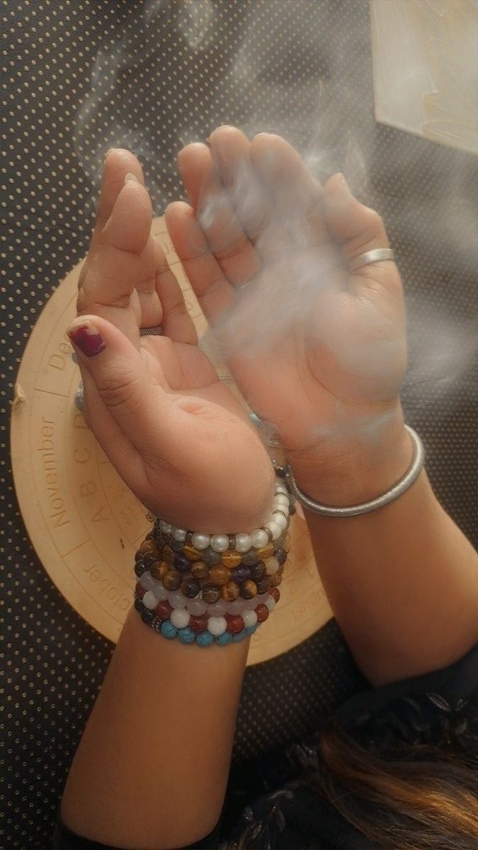 Open hands with smoke rising between them