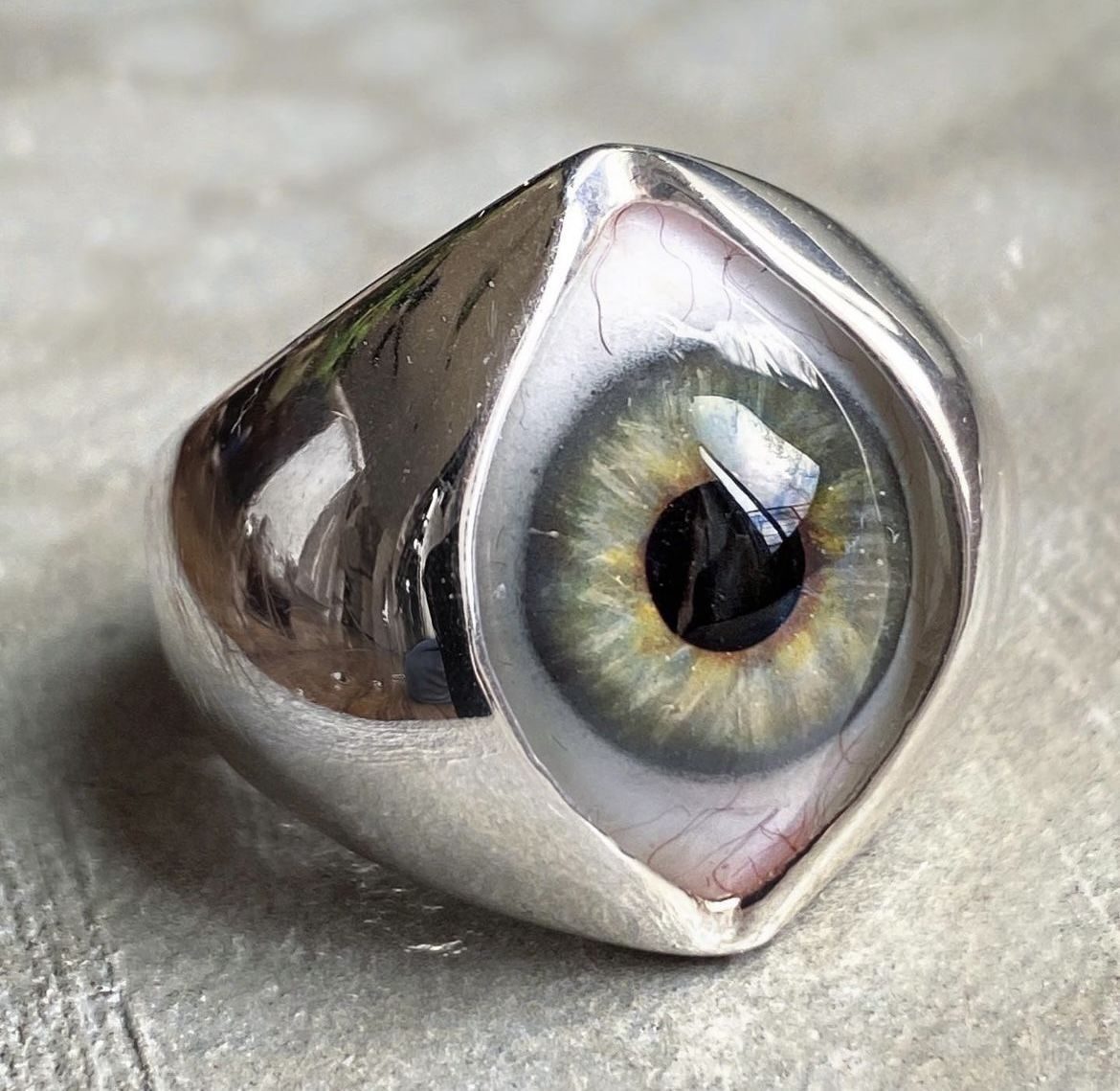 A silver ring set with an eye design